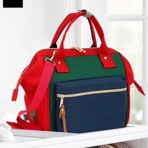 Colorblock diaper bag with red handles and navy blue front pocket