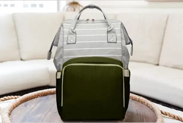 Olive green and grey striped baby diaper bag with large front pocket and shoulder handles